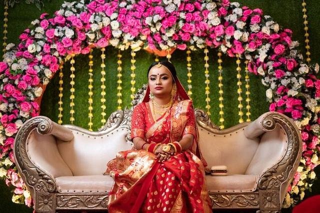 Floral wedding stage with a decorated couple seat